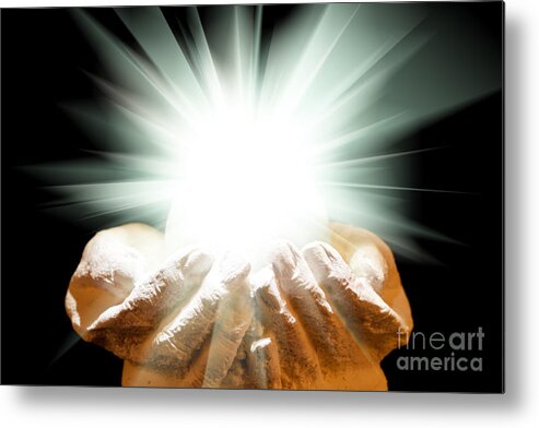 Spiritual Metal Print featuring the photograph Spiritual light in cupped hands on a black background by Simon Bratt