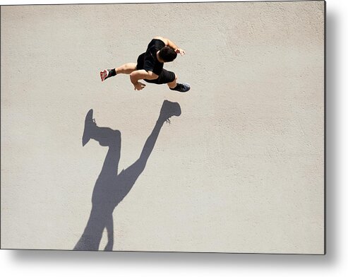 Young Men Metal Print featuring the photograph Sprinter seen from above with shadow and copy space. by Tempura