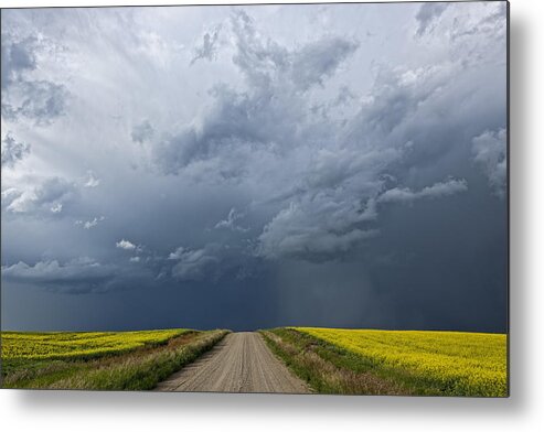 Road Metal Print featuring the photograph Storm Clouds Gather Over A Sunlit by Robert Postma