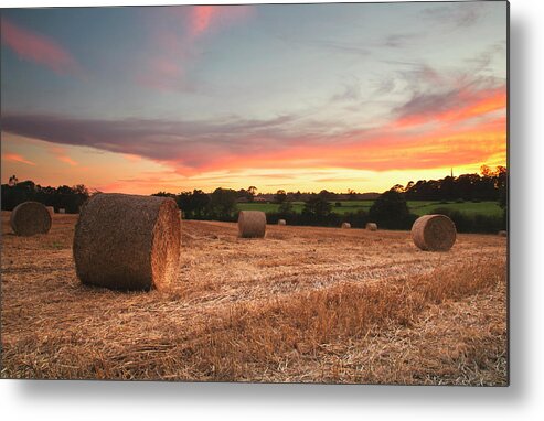 Tranquility Metal Print featuring the photograph Sunset Over Field Of Hay Bales by Verity E. Milligan