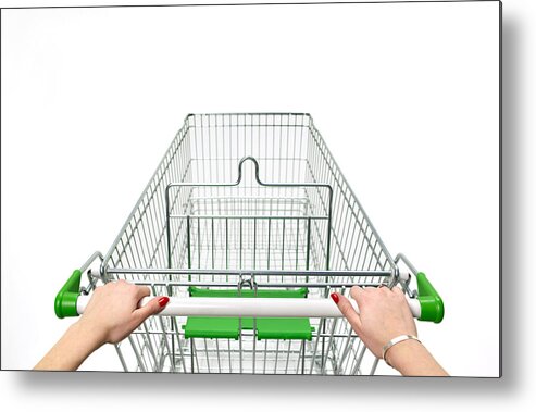 Empty Metal Print featuring the photograph Supermarket trolley with woman's hands on white by Peter Dazeley