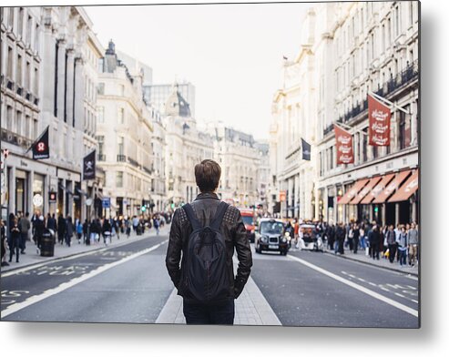 Cool Attitude Metal Print featuring the photograph Tourist with backpack walking on Regent Street in London, UK by Alexander Spatari