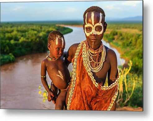 Child Metal Print featuring the photograph Woman from Karo tribe holding her baby, Ethiopia, Africa by Bartosz Hadyniak