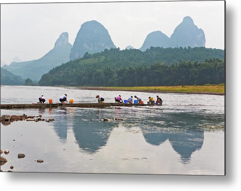 Working Metal Print featuring the photograph Women Washing Clothes By Li River With by Merten Snijders