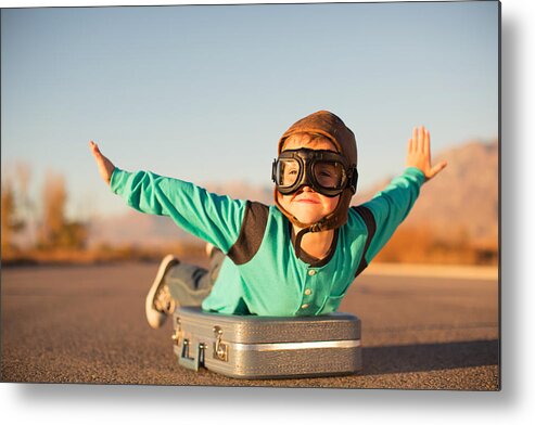 Taking Off Metal Print featuring the photograph Young Boy with Goggles Imagines Flying on Suitcase by RichVintage