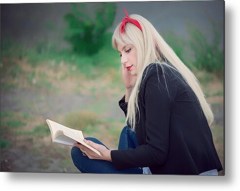 Pop-up Book Metal Print featuring the photograph Young woman relaxing while reading a book at the park by Emilija Manevska