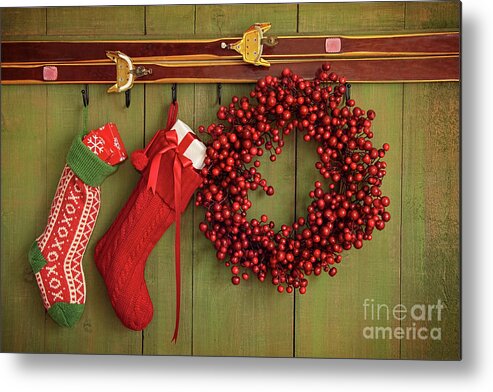 Antique Metal Print featuring the photograph Christmas stockings and wreath hanging on wall by Sandra Cunningham