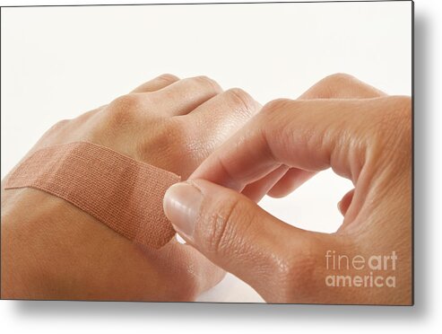 Bandage Metal Print featuring the photograph Two hands with bandage by Blink Images