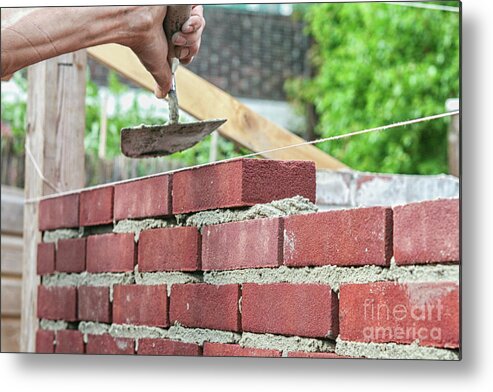 Activity Metal Print featuring the photograph Bricklaying with trowel by Patricia Hofmeester