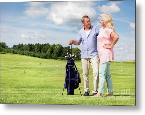 Golf Metal Print featuring the photograph Senior couple enjoying golf game. #1 by Michal Bednarek