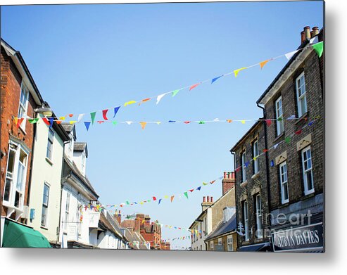 Architecture Metal Print featuring the photograph Street bunting flags #2 by Tom Gowanlock