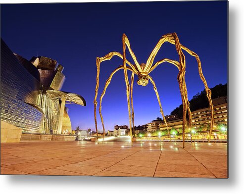 Guggenheim Metal Print featuring the photograph Guggenheim museum and spider at night in Bilbao by Mikel Martinez de Osaba