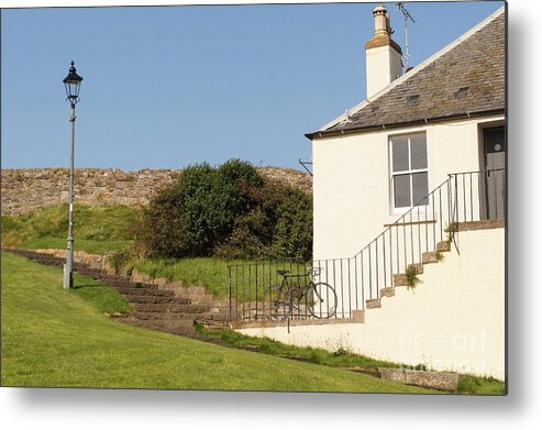 House On The Slope Metal Print featuring the photograph House on the slope with a bike and a lamppost. by Elena Perelman