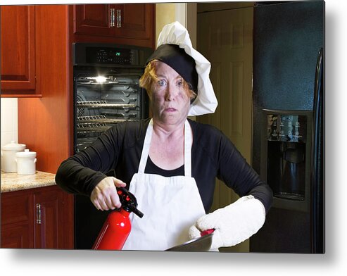 Burning Metal Print featuring the photograph Kichen disaster in apron with fire extinguisher and pan by Karen Foley