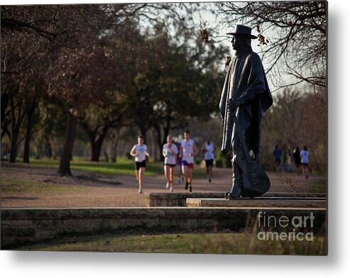 Runners Metal Print featuring the photograph Runners and joggers pass by the Stevie Ray Vaughan Memorial Statue on Lady Bird Town Lake hike and bike trail by Dan Herron