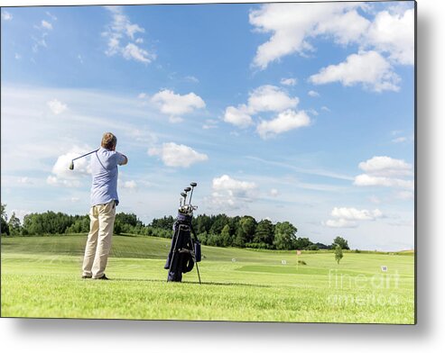 Golf Metal Print featuring the photograph Senior fit man hitting a golf ball. by Michal Bednarek