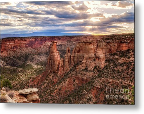 Colorado National Monument Metal Print featuring the photograph The Sun coming up over the Colorado National Monument by Ronda Kimbrow