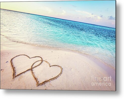 Beach Metal Print featuring the photograph Two hearts drawn on sand of a tropical beach at sunset. by Michal Bednarek