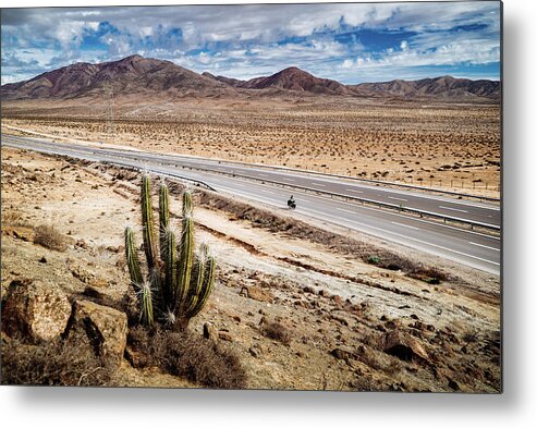 Adventure Metal Print featuring the photograph A cyclist in the Atacama Desert in Chile by Kamran Ali