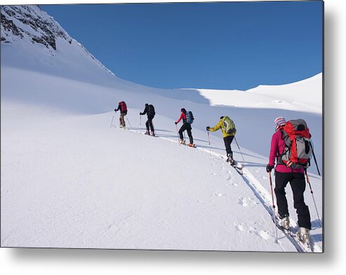 Ski Pole Metal Print featuring the photograph Backcountry Skiers Climbing Snowy Slope by Darryl Leniuk