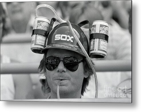 1980-1989 Metal Print featuring the photograph Baseball Fan Wearing Double Beer Hat by Bettmann