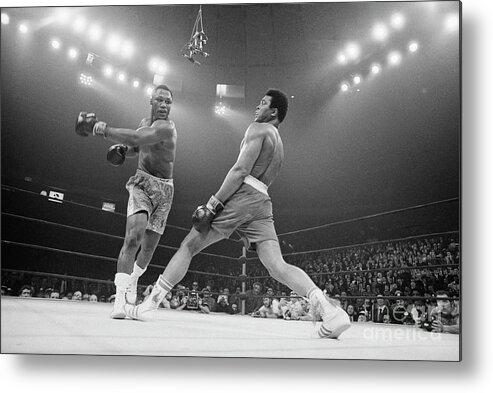 Joe Frazier Metal Print featuring the photograph Boxer Ali Dodging A Punch From Frazier by Bettmann