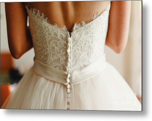 Back Metal Print featuring the photograph Bride getting ready, they help her by buttoning the buttons on the back of her dress. by Joaquin Corbalan