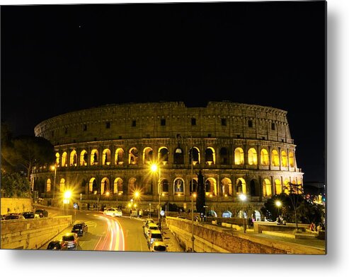 Colosseum At Night Metal Print featuring the photograph Cars speeding by the Colosseum at night by Patricia Caron