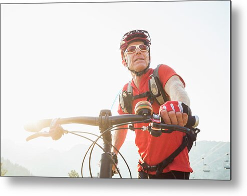 Sports Helmet Metal Print featuring the photograph Caucasian Man Pushing Mountain Bike by Mike Kemp