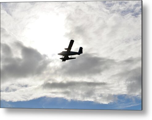 A Seaplane Is Silhouetted Against Clouds Spotlit By The Translucent Glow Of Morning Sun. Metal Print featuring the photograph Escape by Climate Change VI - Sales