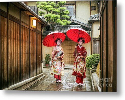 Asian And Indian Ethnicities Metal Print featuring the photograph Geishas Holding Red Umbrellas by Xavierarnau