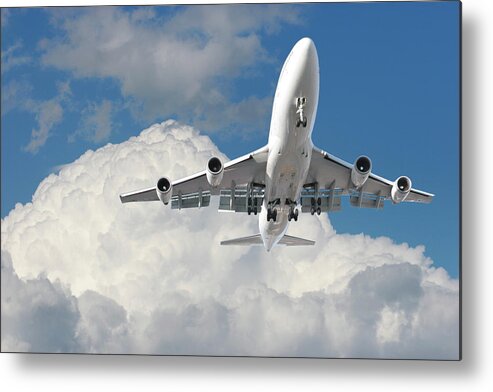 Mid-air Metal Print featuring the photograph Large Airplane Flying Above A Cloudy Sky by Buzbuzzer