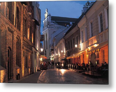 Part Of A Series Metal Print featuring the photograph Lithuania, Vilnius, Illuminated Street by Peter Adams
