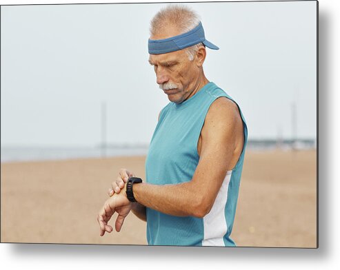 Man Metal Print featuring the photograph Modern Aged Man With Fitness Bracelet by Cavan Images