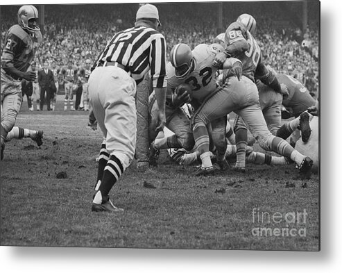 Jim Brown Metal Print featuring the photograph Opponents Tackling Jim Brown by Bettmann