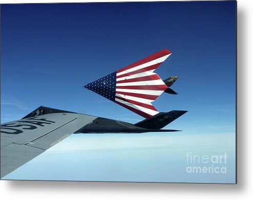 Kc-135 Stratotanker Metal Print featuring the photograph Pilots Refueling A Pair Of F-117 by Stocktrek Images