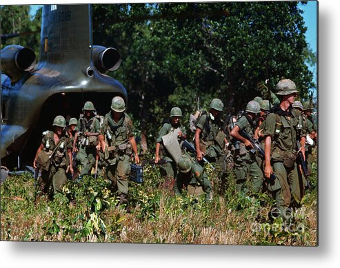 Vietnam War Metal Print featuring the photograph Soldiers Exiting Helicopter by Bettmann