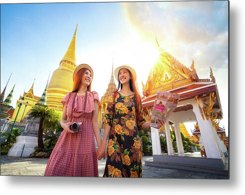 Bangkok Metal Print featuring the photograph Two asian girlfriends traveling and check location by a map in G by Anek Suwannaphoom