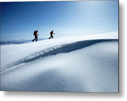 Young Men Metal Print featuring the photograph Two Backcountry Skiers Hiking In Fresh by Trevor Clark