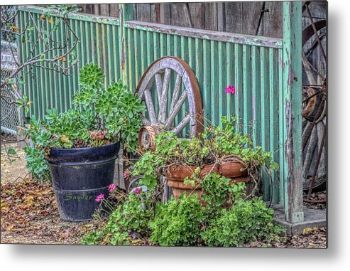 Wagon Wheels And Potted Plants Metal Print featuring the photograph Wagon Wheels and Potted Plants by Barbara Snyder