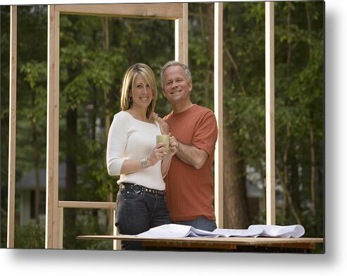 White People Metal Print featuring the photograph Couple reviewing blueprints at construction site #1 by Comstock Images