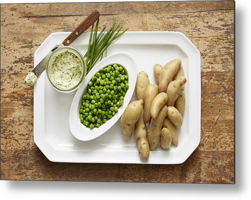 Wood Metal Print featuring the photograph Fingerling potatoes and spring peas served with a chive compound butter #1 by Ryan Benyi Photography