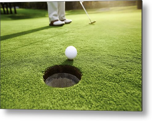 Putting Green Metal Print featuring the photograph Man playing golf #1 by Orbon Alija