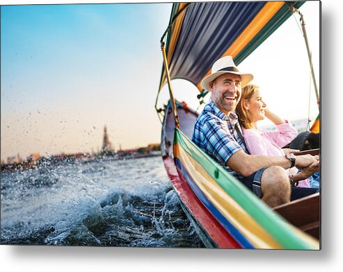 Heterosexual Couple Metal Print featuring the photograph Middle-aged man and his companion handsome blond lady on a boat ride in Bangkok #1 by Itsskin