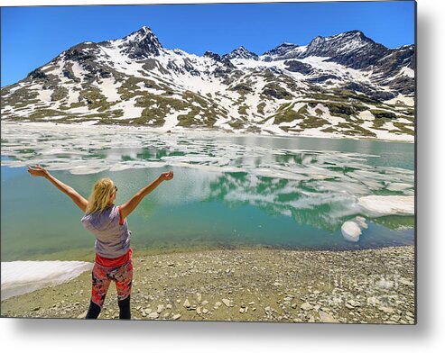 Switzerland Metal Print featuring the photograph woman on Swiss White lake trekking #1 by Benny Marty