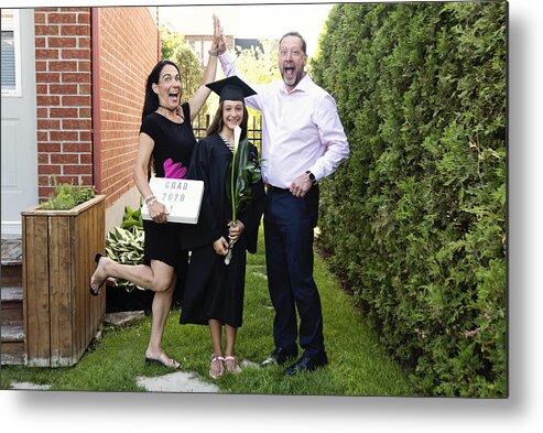 Education Metal Print featuring the photograph Teenage girl graduation from primary school family portrait in backyard. #5 by Martinedoucet