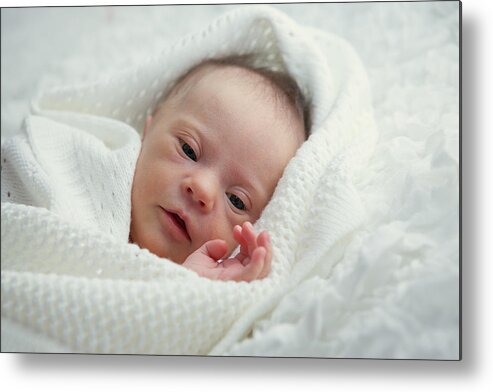 Blanket Metal Print featuring the photograph A baby cuddled up in a white blanket by Eleonora_os