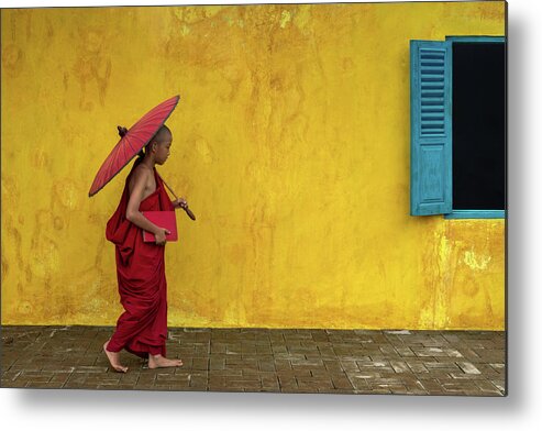 Novice Metal Print featuring the photograph A novice monk walking by by Anges Van der Logt
