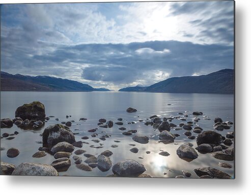 Scenics Metal Print featuring the photograph A view across Loch Ness looking down the length of the lake with rocks inn the foreground and dark clouds above, in Scotland by Luke Richardson