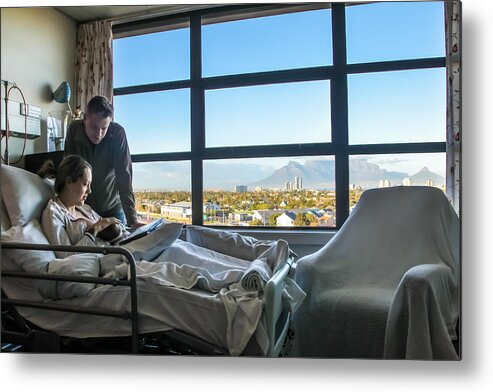 Maternity Hospital Metal Print featuring the photograph a Young man spends time with his wife in hospital as she recovers from a caesarean section. by Petri Oeschger